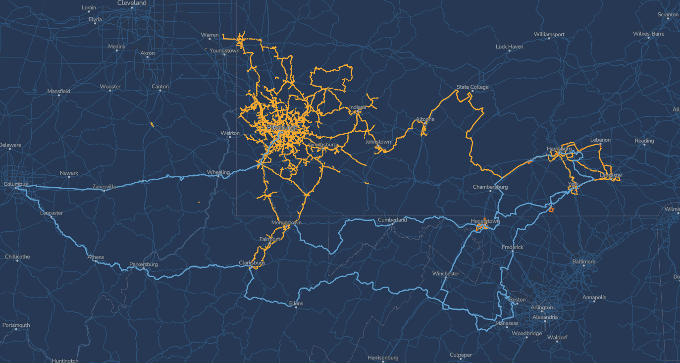 A dark blue map shows two networks: orange lines cluster in the Wheeling, WV area, while blue lines connect Wheeling, Columbus, Pittsburgh, and extend south through West Virginia, crossing various towns and cities.
